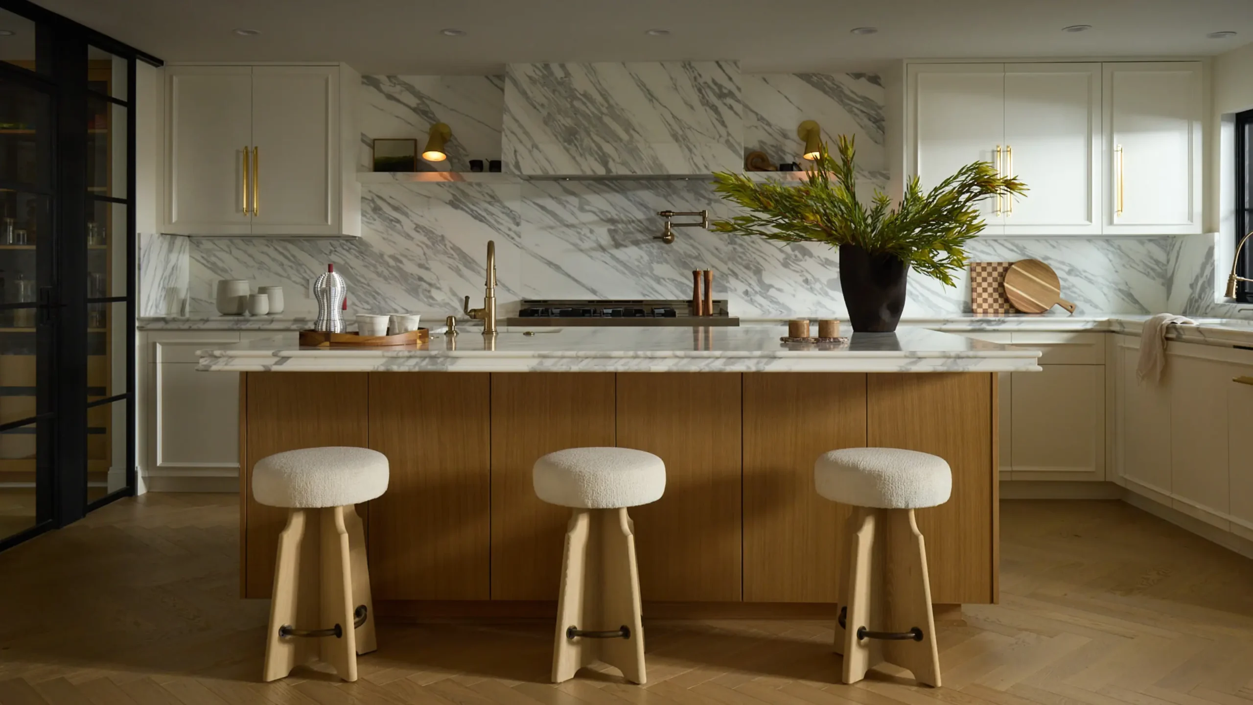 Luxury kitchen detail showing precision joinery, waterfall worktop and gold hardware finish