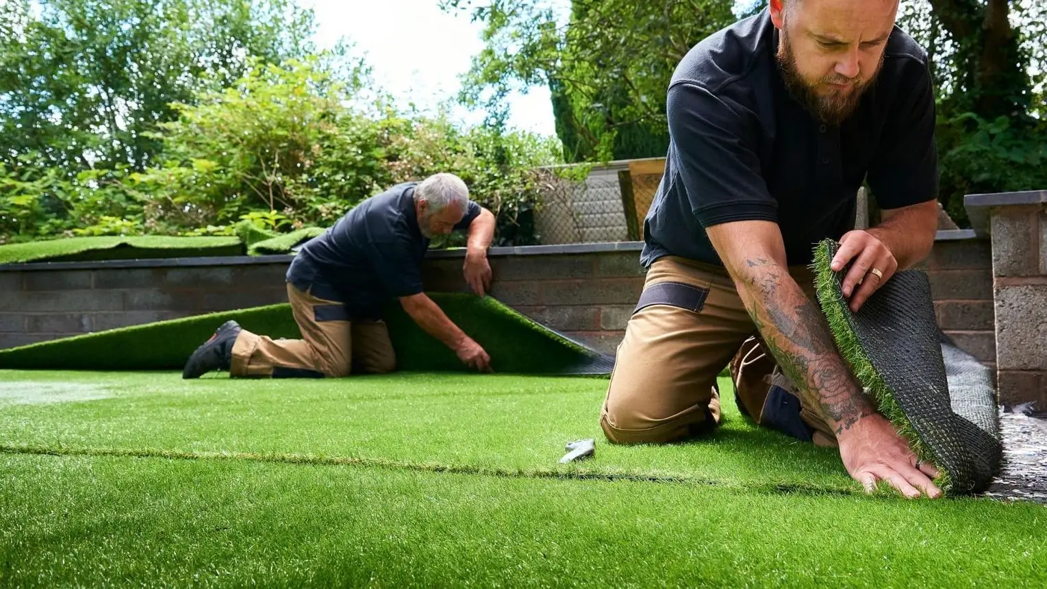 Professional artificial grass dubai installation in progress by technicians