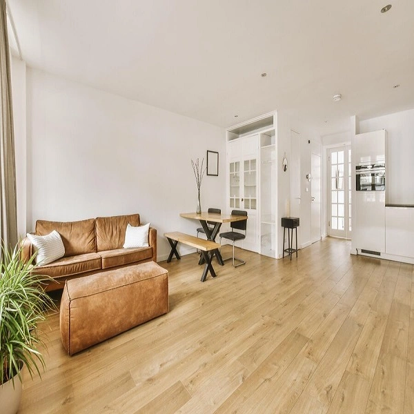 Laminate flooring installed in a modern loft-style kitchen and living space