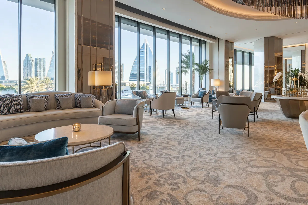Hotel lounge and lobby seating area in Dubai with patterned contract carpet in neutral tones